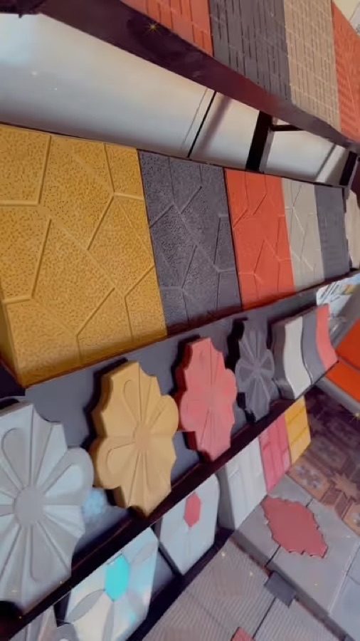 Flower tiles in several colours on the factory rack